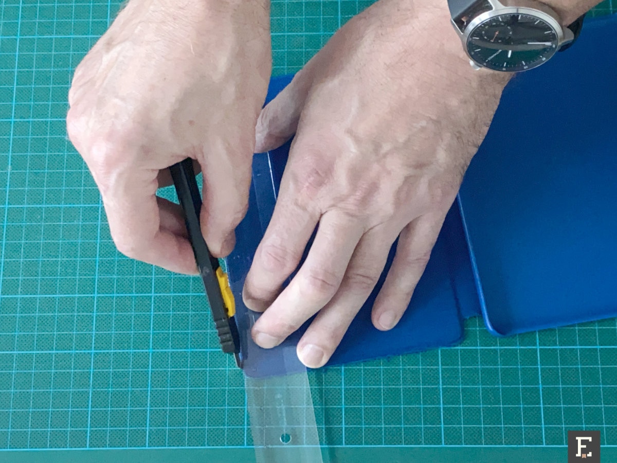 Use box cutter to remove fabric from the edges of the old Kindle case